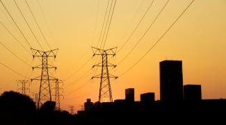 Sunset image with power lines and city